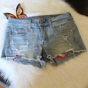American Eagle Outfitters distressed jean shorts with floral pockets